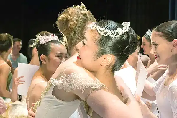 support the RAD | Royal Academy of Dance dancers hugging after a competition