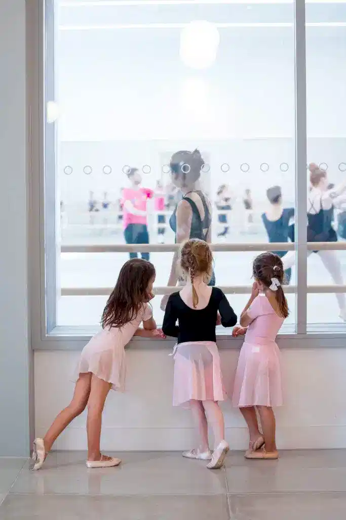 safeguarding HQ image 2 | Royal Academy of Dance 3 young dancers looking into an RAD studio